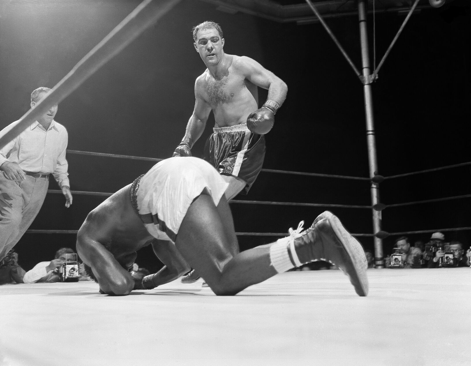 1954: Rocky Marciano knocks out Ezzard Charles to retain title